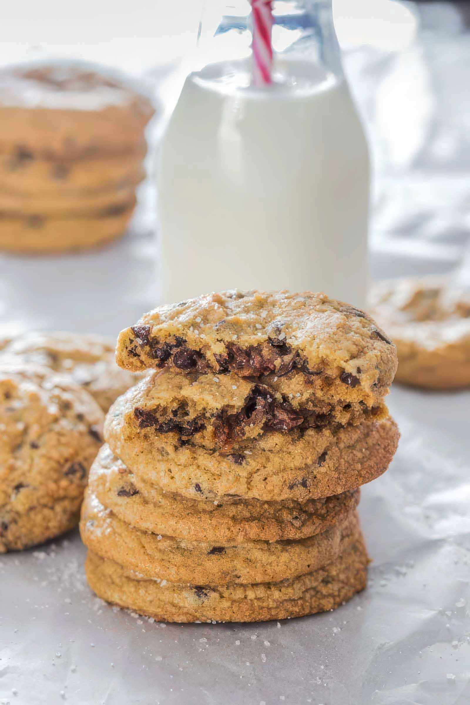 Stack of salted caramel stuffed cookies sprinkled with flaky sea salt.